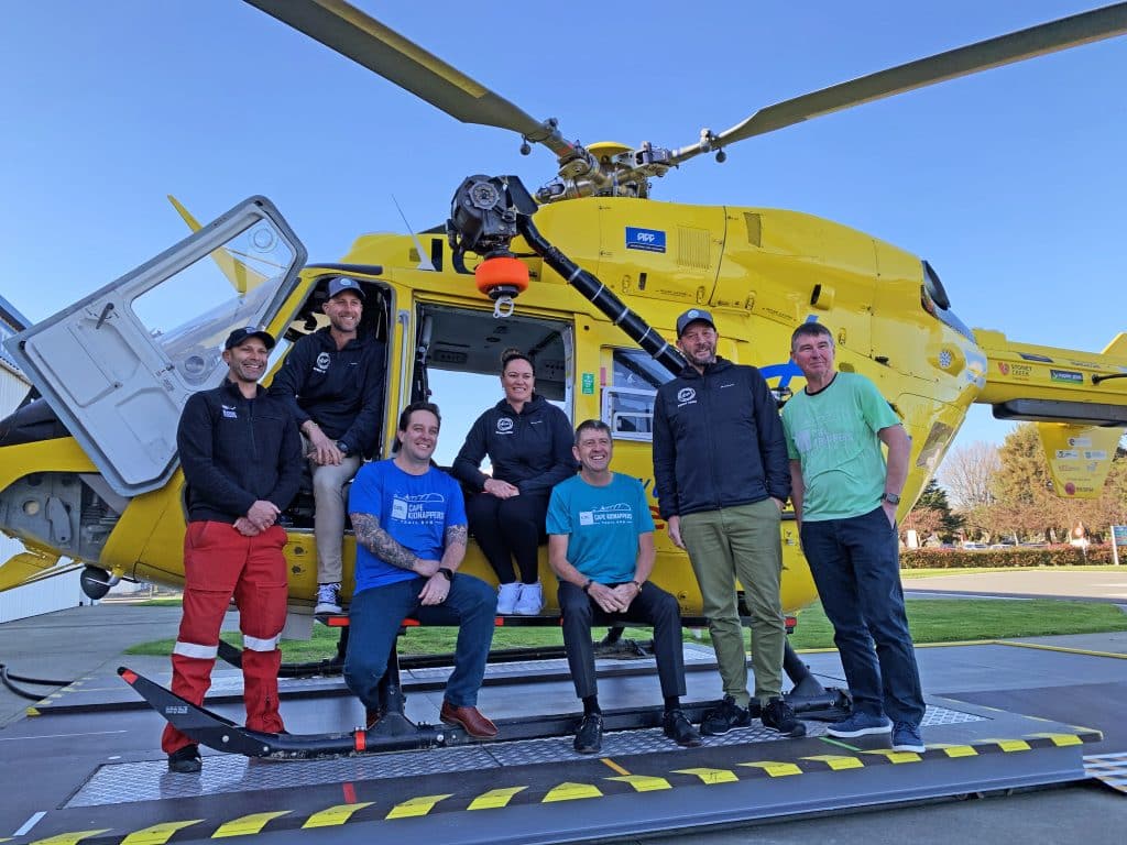 The Cole Murray team with Total Sport who run the Cole Murray Cape Kidnappers Trail Run, alongside with the Hawkes' Bay Rescue Helicopter.